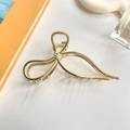 Elegant gold liquid line bow hair claw clip made of polished metal for women - Bow Tie Bright Gold