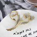 Elegant gold tulip hair claw clip with rhinestones and pearl on a white ceramic tray - Gold Tulip