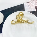 Golden liquid metal bow hair claw clip with a central pearl embellishment - Gold Pearl Bow