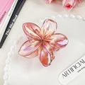Iridescent pink plumeria hair claw clip with aurora finish on a pearl edge plate - Garnet Red