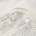 Iridescent pearlescent wave-shaped large claw clip on a book background for hair styling - M-Shape 9CM