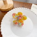 Rainbow marbled acetate flower hair claw clip displayed on a white ceramic plate - Flower Dark 6.6CM