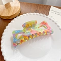 Colorful acetate hair claw clip with rainbow marble texture in a white ceramic dish - Cat Ear Dark 12.5CM