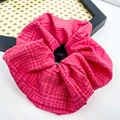 Scrunchie rosa con trama a scacchi su un vassoio decorativo esagonale in rattan - Rosso Bacca