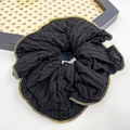 Elegant black scrunchie with golden metallic edges in a stylish pleated fabric design - Gold Black