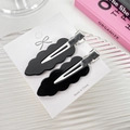 Set of two black wavy acrylic hair clips on a white card display with stylish background - 6cm / Black
