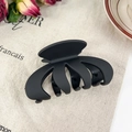 Matte black oversized wave hair claw clip for thick hair displayed on linen - Pumpkin Black