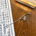 Silver lotus hair pin with blooming flower design and metallic finish on wooden desk - Lotus Style