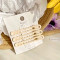 Set of three wave-shaped cream hair clips on a white display card with summer floral decor - 6cm / Milk White