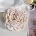 Elegant off-white fabric camellia hair clip with layered petals on a magazine - 12cm / Off-white