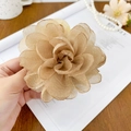 Elegant champagne organza flower hair claw clip held by hand against a warm background - 10cm / Brown