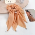 Coletero elegante color albaricoque con lazo grande, perlas y gasa con brillo suave - Naranja