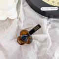 Handmade flower hair clip featuring deep amber and blue marble textured acetate design - Blue Brown