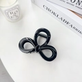 Glossy black bow-shaped shark clip on minimalist background with candle and book - Bofeiya Direct Sale / Solid Black 8.2cm