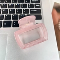 Matte light pink square hollow hair claw clip placed on a laptop keyboard - Square Pink
