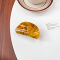 Elegant amber tortoise shell hair claw clip with gold glitter and d-shaped acrylic design - Tan