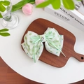 Floral and checkered green bow hair scrunchie with heart crystal on wood surface - Rhinestone Bow