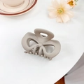Matte taupe hair claw clip with large bow design on a minimalist home setup background - Bowknot Moon Gray 8CM