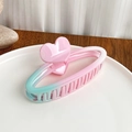 Pink and mint green gradient claw clip with heart design on a ceramic tray - Oval Hair Claw
