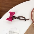 Pinza tipo banana con lazo rosa fucsia y acabado con textura ámbar oscuro - Rosa rojo