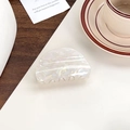 Elegant semi-round hair claw with pearlescent finish in a lifestyle photo setting - Semi-circular Off-white