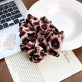 Leopard print scrunchie hair tie on a stylist desktop with fashion accessories - Red Leopard