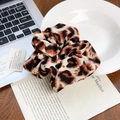 Chic leopard print satin scrunchie for women on a stylish desk setting - Orange Leopard