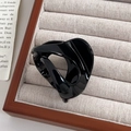 Glossy black pumpkin hair claw clip in a twist design for an elegant ponytail look - Black