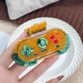 Haarklammer im Retro-Game-Controller-Design aus bernsteinfarbenem Marmor-Harzmaterial - Gamecontroller