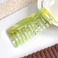Elegant wide-tooth acetate hair comb featuring green and yellow marble patterns - Shimmering Green