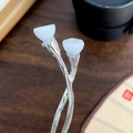 Elegant silver lotus bud hair pin for buns with white faux jade on dark wood background - White