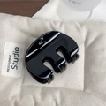 Glossy black M-shaped medium hair claw clip in a minimalist resin finish for daily use - Black