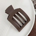 Matte dark brown square hair claw clip with geometric hollow design on a white ceramic plate - Khaki 9.3cm