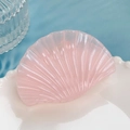 Pink jelly seashell hair claw clip with pearlescent finish on a decorative white plate - Pink Shell