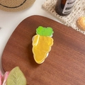 Carrot-shaped hair claw clip with yellow marble texture and green leaf detail - Carrot