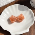 Vintage orange acrylic bow hair clip with white line detail on shell ceramic plate - Orange / 6.5cm