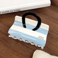 Blue and white striped acetate hair claw clip with black U-shaped handle design - Blue and White Stripes