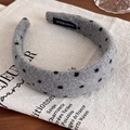 Detail of gray plush polka dot headband featuring a white Handmade label on the inner lining - Grey Polka Dot