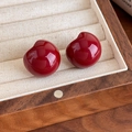 Macro shot of red cherry-shaped earrings on a wooden jewelry box with beige lining - Wine Red (27859B)