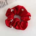 Close-up of red satin scrunchie with white imitation pearls on a minimalist background - Red Pearl Decor Satin Style (19789)
