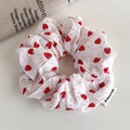 Detail of white strawberry print scrunchie with brand label and vintage linen backdrop - White Strawberry Seersucker Style (27270B)