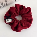 Close-up of wine red ribbed fabric scrunchie with black bow and handmade label detail - Wine Red Ribbed Bow Style (26193A)