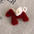 Macro detail of a plush horse brooch with felt wings, wooden button and fabric tag - Red Pony (27870E)
