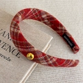 Detail view of red plaid headband with gold metal button and handmade woven label - Red Striped Plaid (27878C)