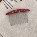 Close-up of red polka dot acetate comb with silver metal teeth for elegant hairstyling - Polka Dot Style / Red