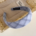 Detail of blue plaid padded headband with handmade label in a rustic woven basket - Blue Small Plaid