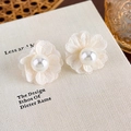 Close-up of cream chiffon fabric flower earrings with glossy white pearl center detail - Beige Flower