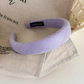 Detailed macro view of handmade label on a purple textured sponge padded headband - Light Purple