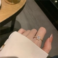 Elegant gold ring with a rectangular zircon and side diamonds on a model's hand - Gold Square Zircon Ring