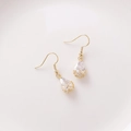 Detail of drop-shaped zircon earrings with golden floral hollow base and crystal pendants - A Drop Style